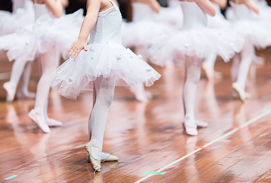 young ballerinas wearing tutus in dance class